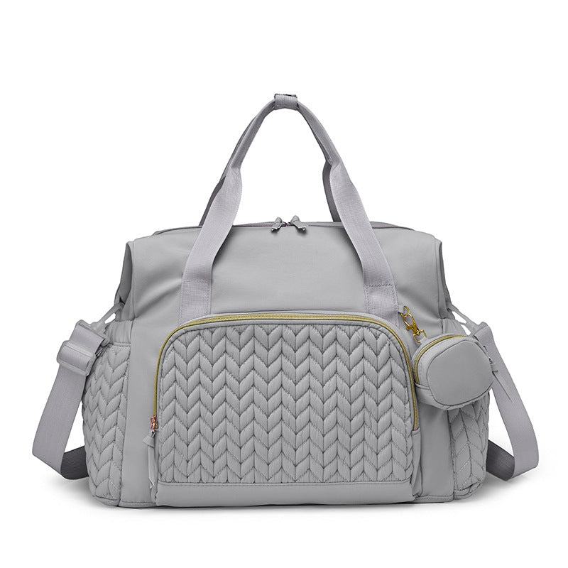 Graue Wickeltasche mit gestepptem Muster und Rundtasche