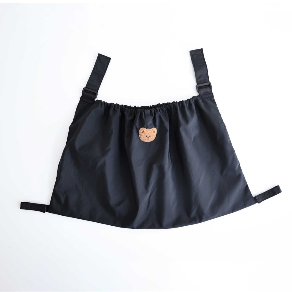 Kinderwagen-Netztasche in Schwarz mit Gurten und Bärchen-Aufnäher, freigestellt