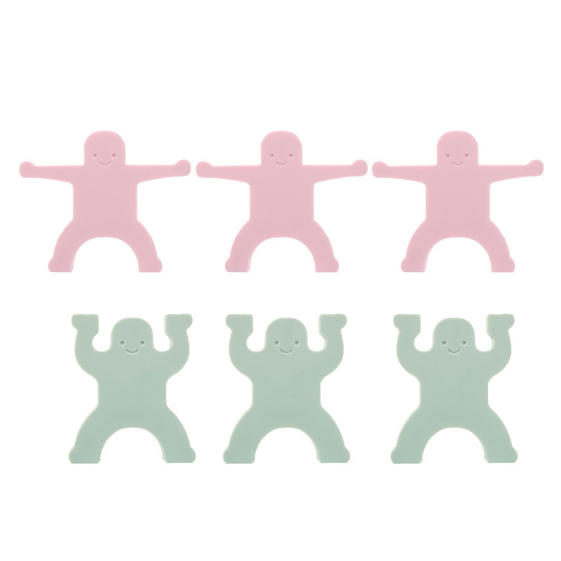 Sechs Stapelfiguren aus Silikon, drei in Rosa mit ausgestreckten Armen und drei in Mint mit erhobenen Armen