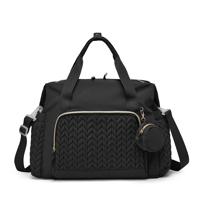 Schwarze Wickeltasche mit gestepptem Muster und Rundtasche