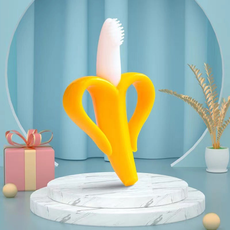Bananen-Beißer aus gelbem Silikon mit weißem Bürstenkopf auf einem Podest