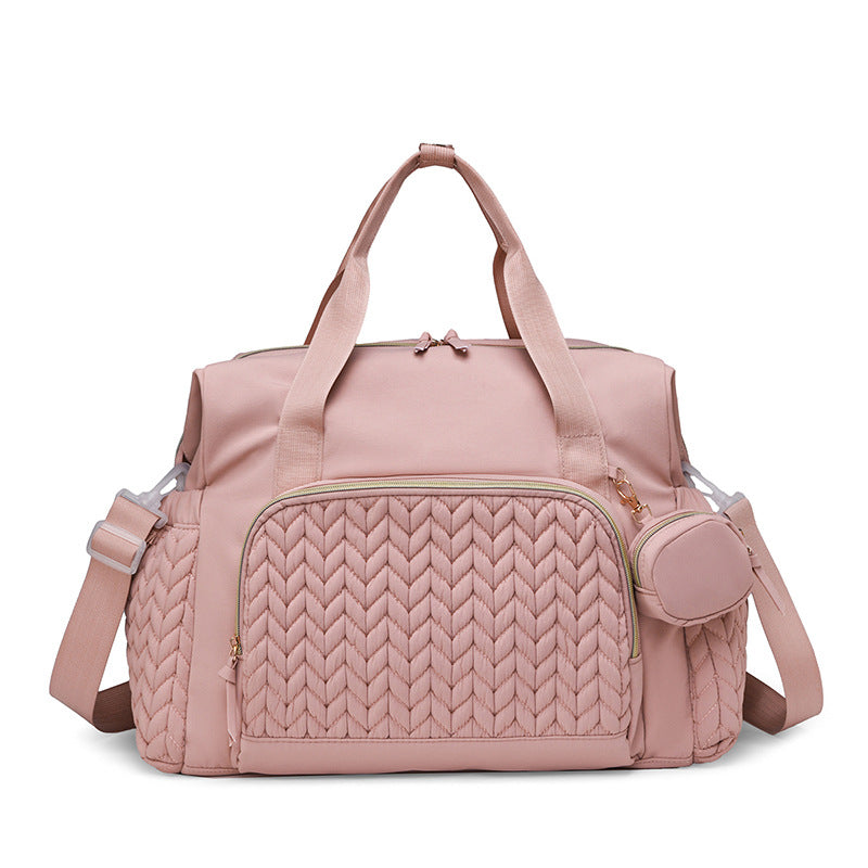 Rosafarbene Wickeltasche mit gestepptem Muster und Rundtasche