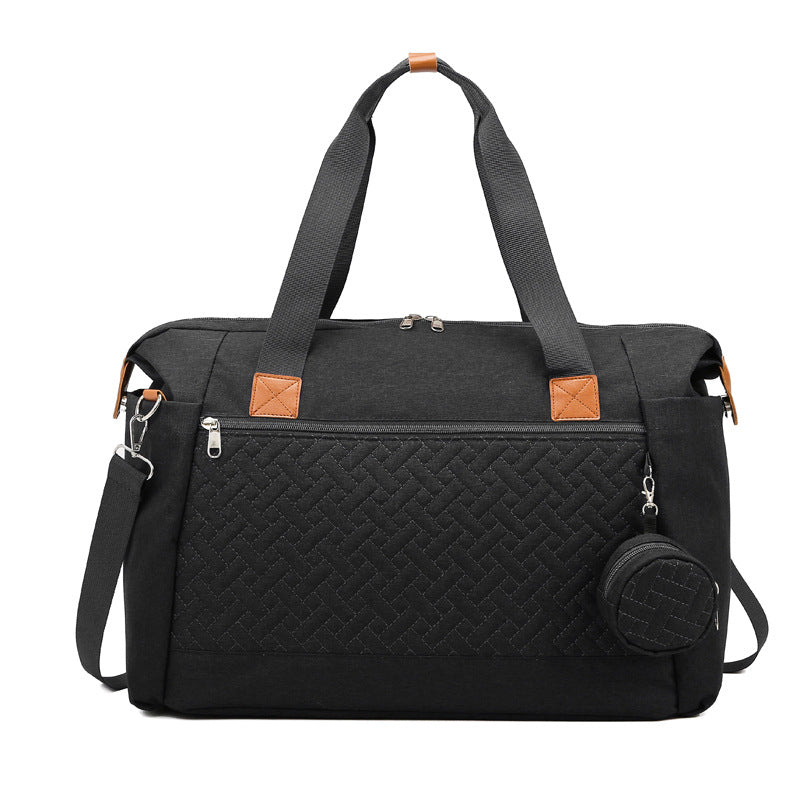 Große schwarze Wickeltasche mit Steppmuster, Rundtasche und Schultergurt
