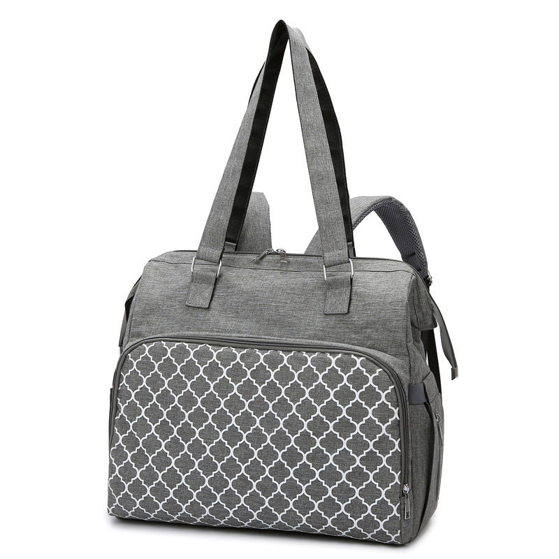 Graue Wickeltasche mit Gittermuster, Henkeln und Rucksackgurten