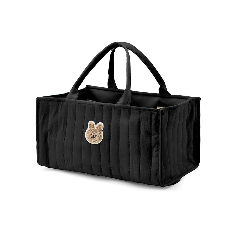 Schwarzer Windel-Caddy schräg von der Seite mit aufgestellten Griffen