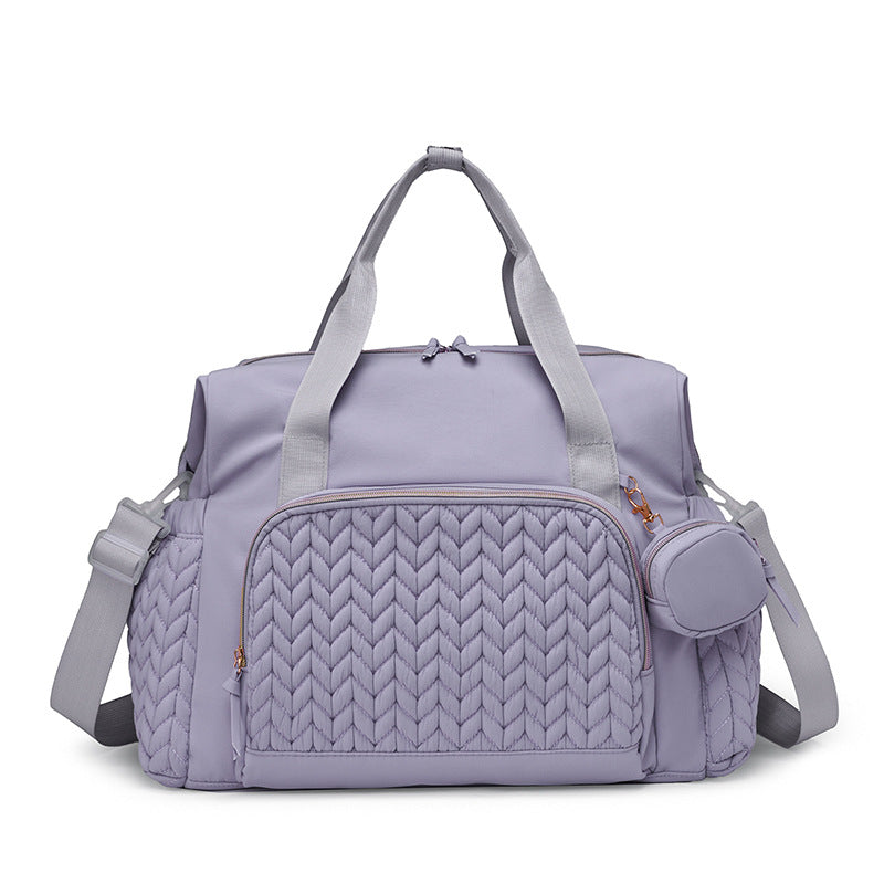 Lilafarbene Wickeltasche mit gestepptem Muster und Rundtasche