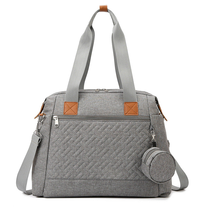 Kleine graue Wickeltasche mit Steppmuster, Rundtasche und Schultergurt